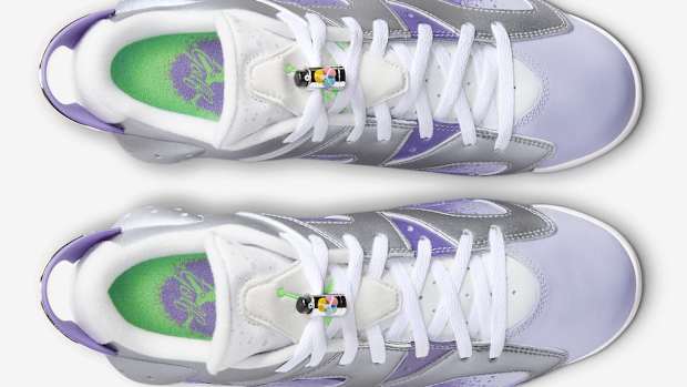 Overview of purple and grey Air Jordan golf shoes.